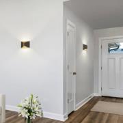 Helestra LED-væglampe VID, sort/guld, op/ned, IP65