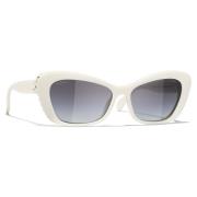 Elegante ovale solbriller med hvid acetatramme