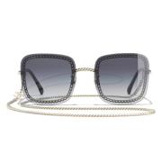 Stilfulde solbriller med sort metalstel og degraderet filter